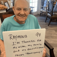 Raymond senior man has a thanksgiving sign saying he is thankful for his wife and family