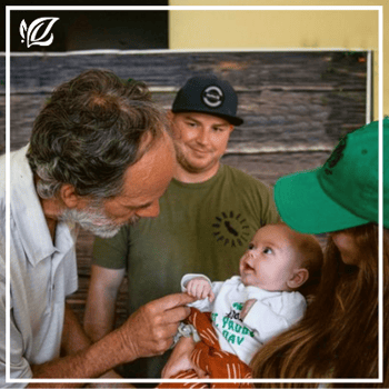 a resident at newport mesa meets his grandchild for the first time 