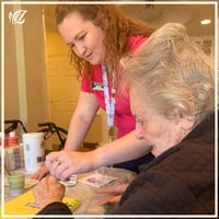 Tammi Rix of Pacifica Tampa gardens does crafts with a senior resident