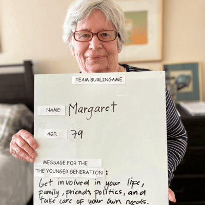 margaret from burlingame holds a sign with mothers day advice