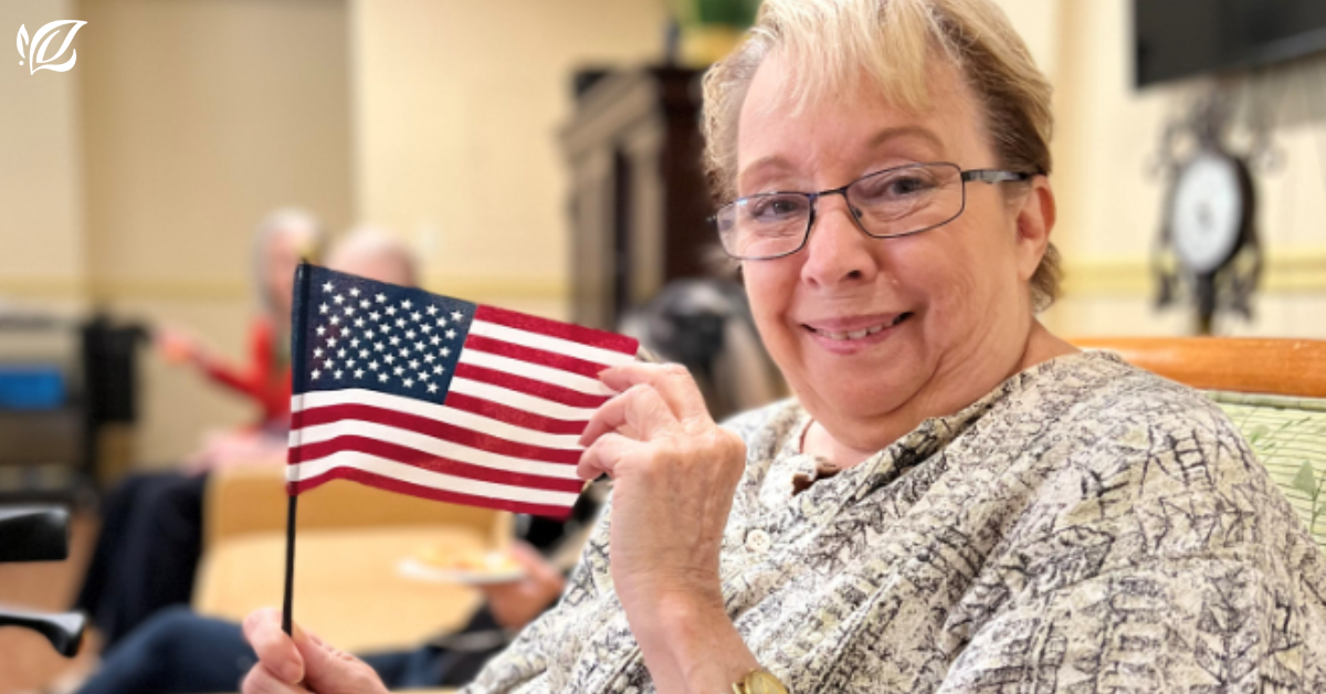 pacifica burlingame resident holds an American flag
