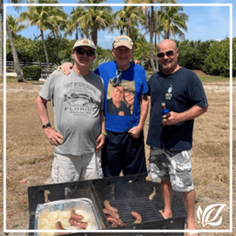 three senior men from pacifica fort myers enjoy an outdoor barbeque