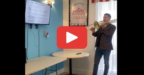 video of George tickles play trombone while residents of pacifica mission villa sing fly me to the moon