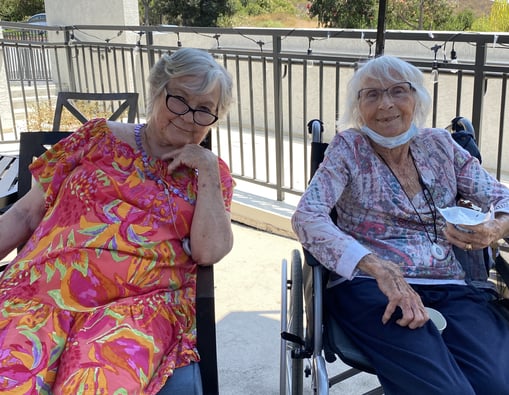 two resident senior women from pacific senior living rancho penasquitos smile at the camera