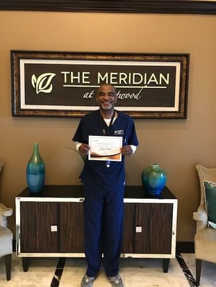 jarmo of Meridian at Westwood holds up an employee appreciation award