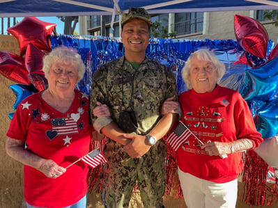 Joyce and Joanne from meridian at laguna hills pose with activity director at an Independence Day event