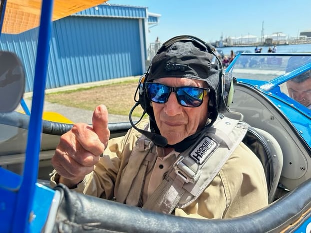 Fred F of Tampa gardens Senior Living gives a thumbs up before his Dream Flights ride over Tampa