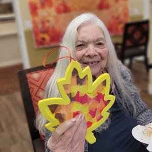 Pacifica senior living resident shows of her paper cache leaf craft