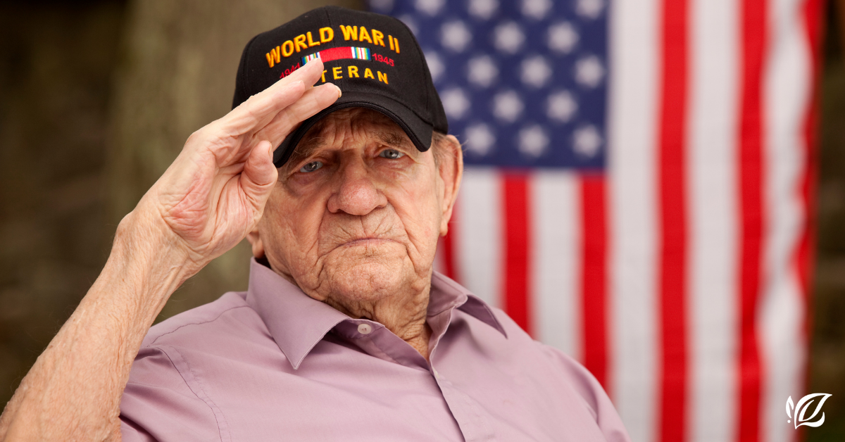 World war II veteran salutes in front of the American flag